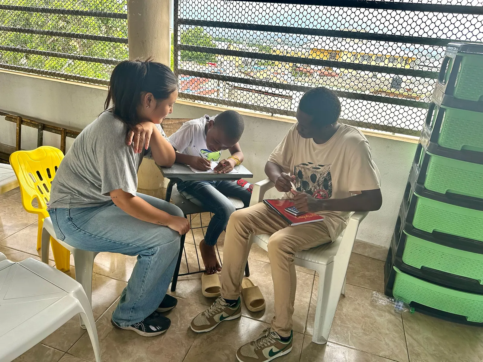 A HADA teacher working one-on-one with a student at a small desk