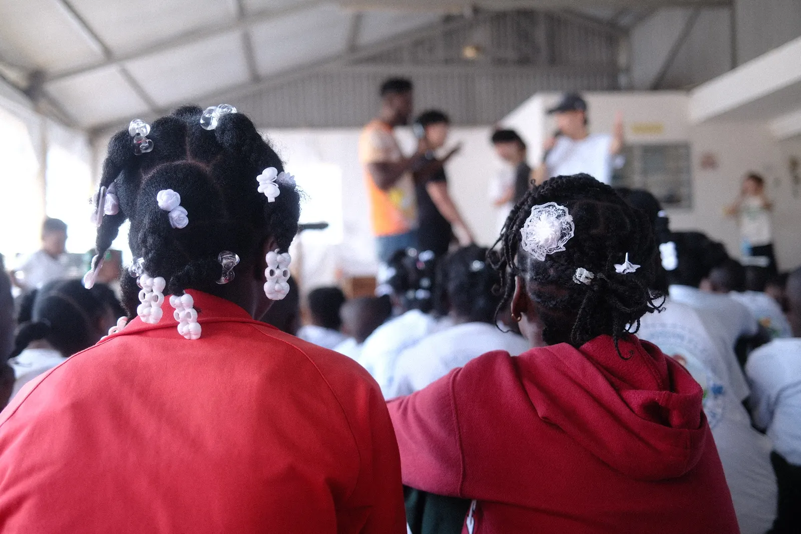 Students watching a lesson at a community gathering